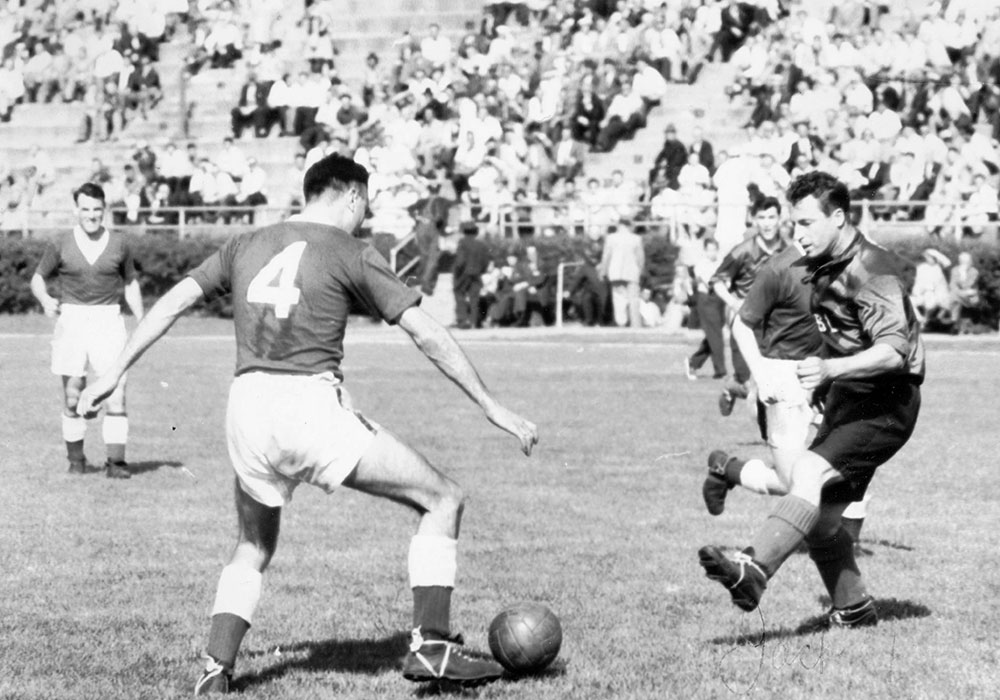 Matt Woods on the ball watched by Cyril Lello